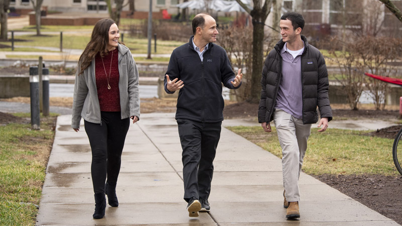 Outdoor photo of group walking and talking